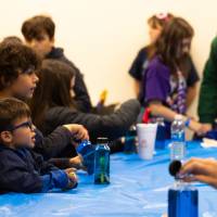 kids participating in the make a sea bottle event at sibs and kids weekend